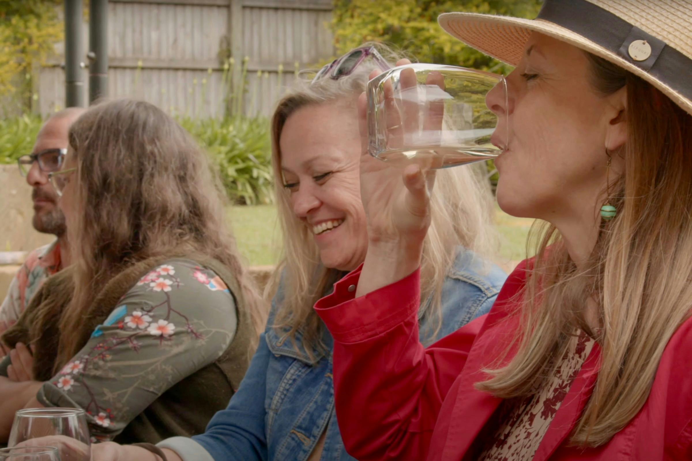 Women sitting at a table and sampling wine at Witches Falls Winery
