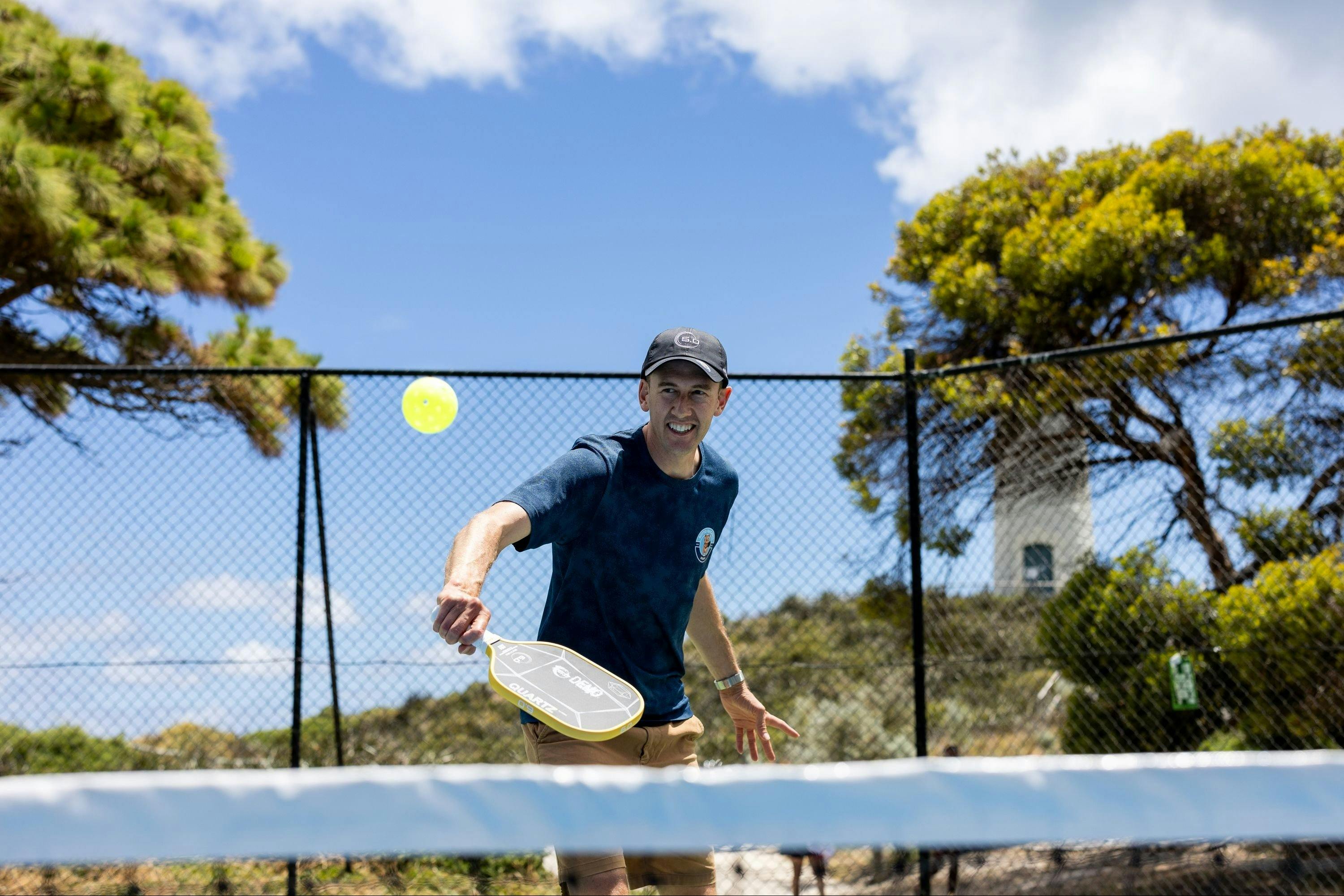 A player returning a shot during a game of pickleball at Rotto Rackets Sports.