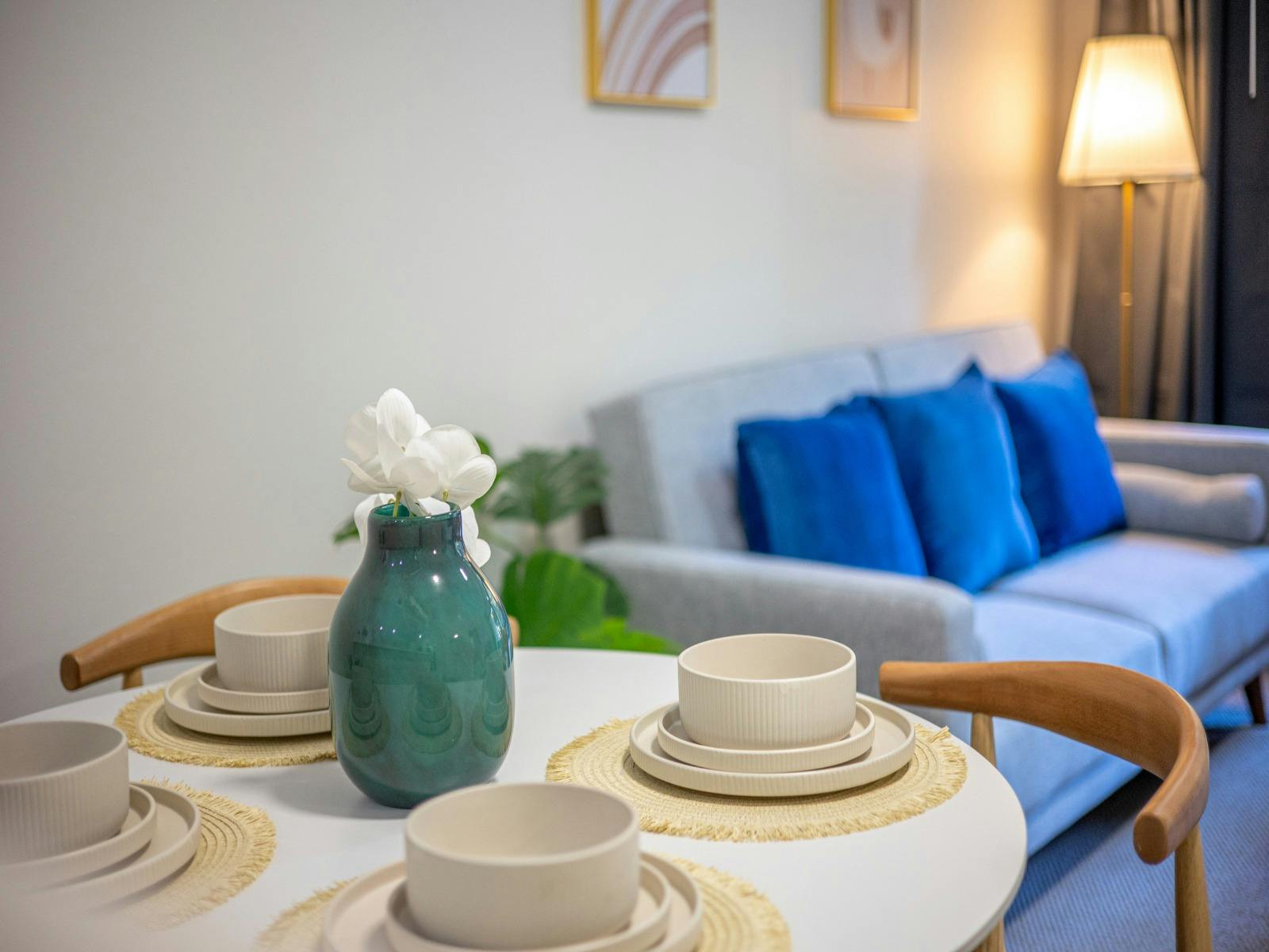 Dining table set for four positioned beside the living area.
