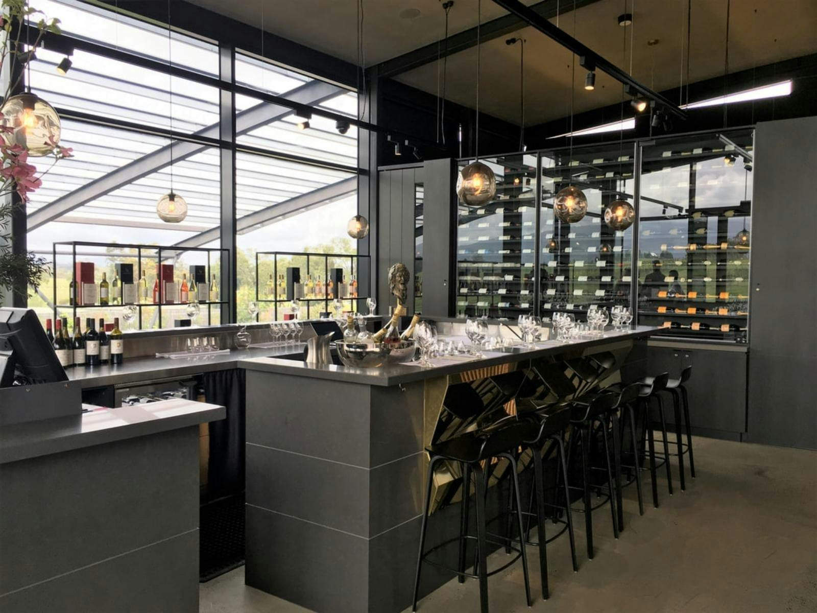 Exploring wine options at Levantine Hill during a helicopter wine tour.