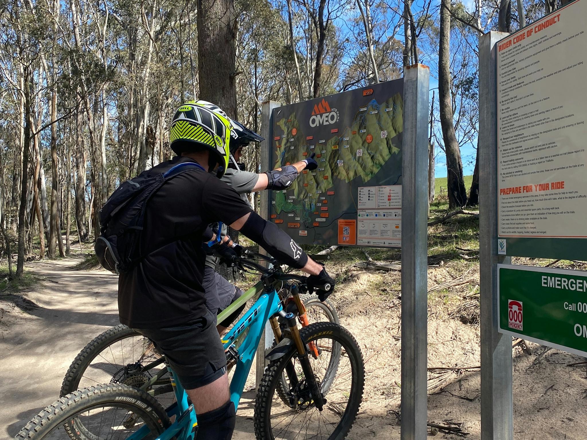 Gravity Dirt Co. riders checking out the trail map at Omeo Mountain Bike Park.