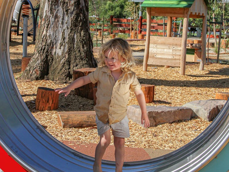 Child on hamster wheel in playground