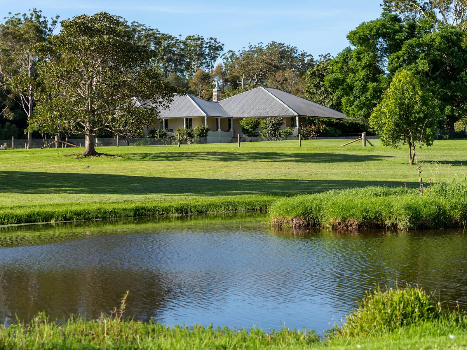 the historic homestead capturing the views over the sprawling lawns and dam