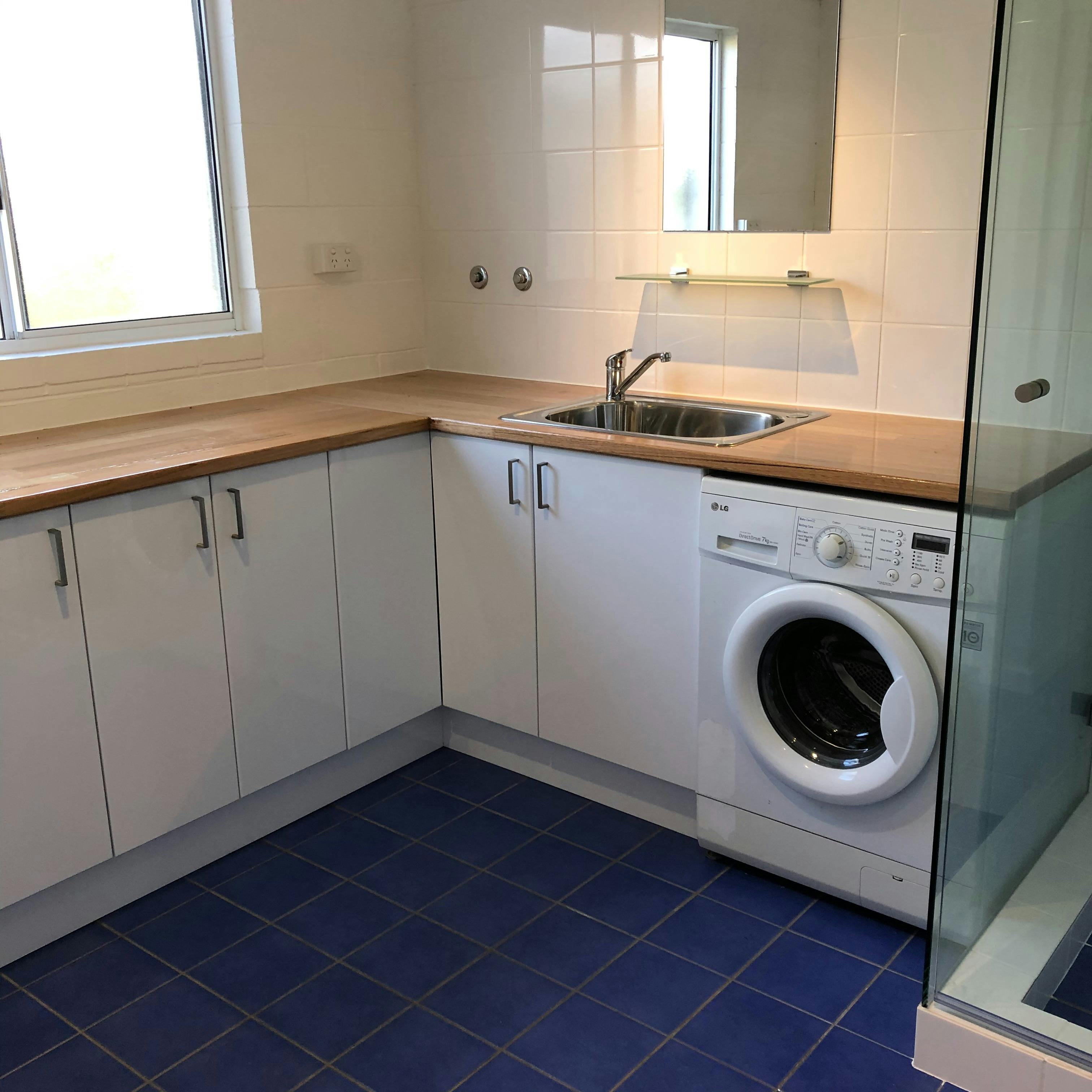 Combined laundry, shower room, kitchenette with separate toilet