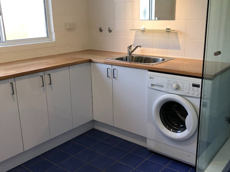 Combined laundry, shower room, kitchenette with separate toilet