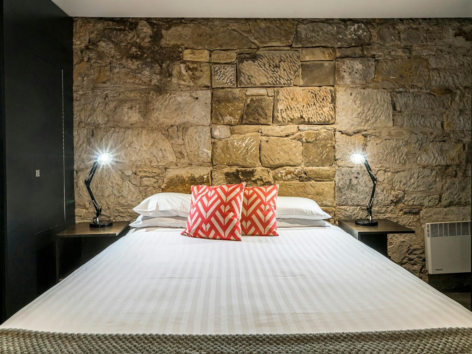 Stunning modern bedrooms in an historic convict sandstone Salamanca Place building.