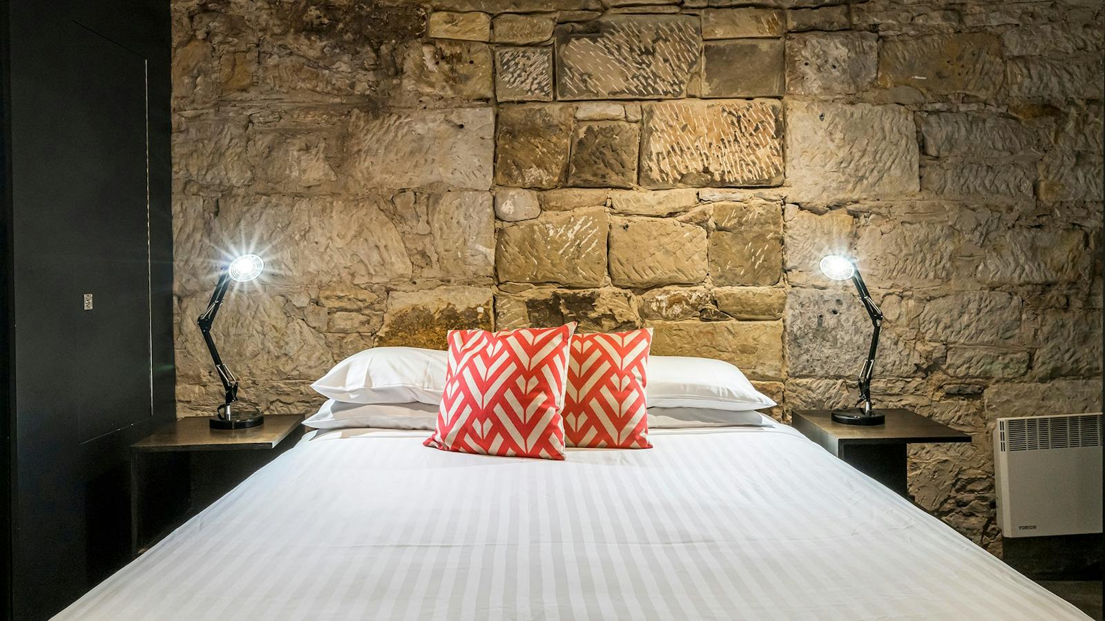 Stunning modern bedrooms in an historic convict sandstone Salamanca Place building.