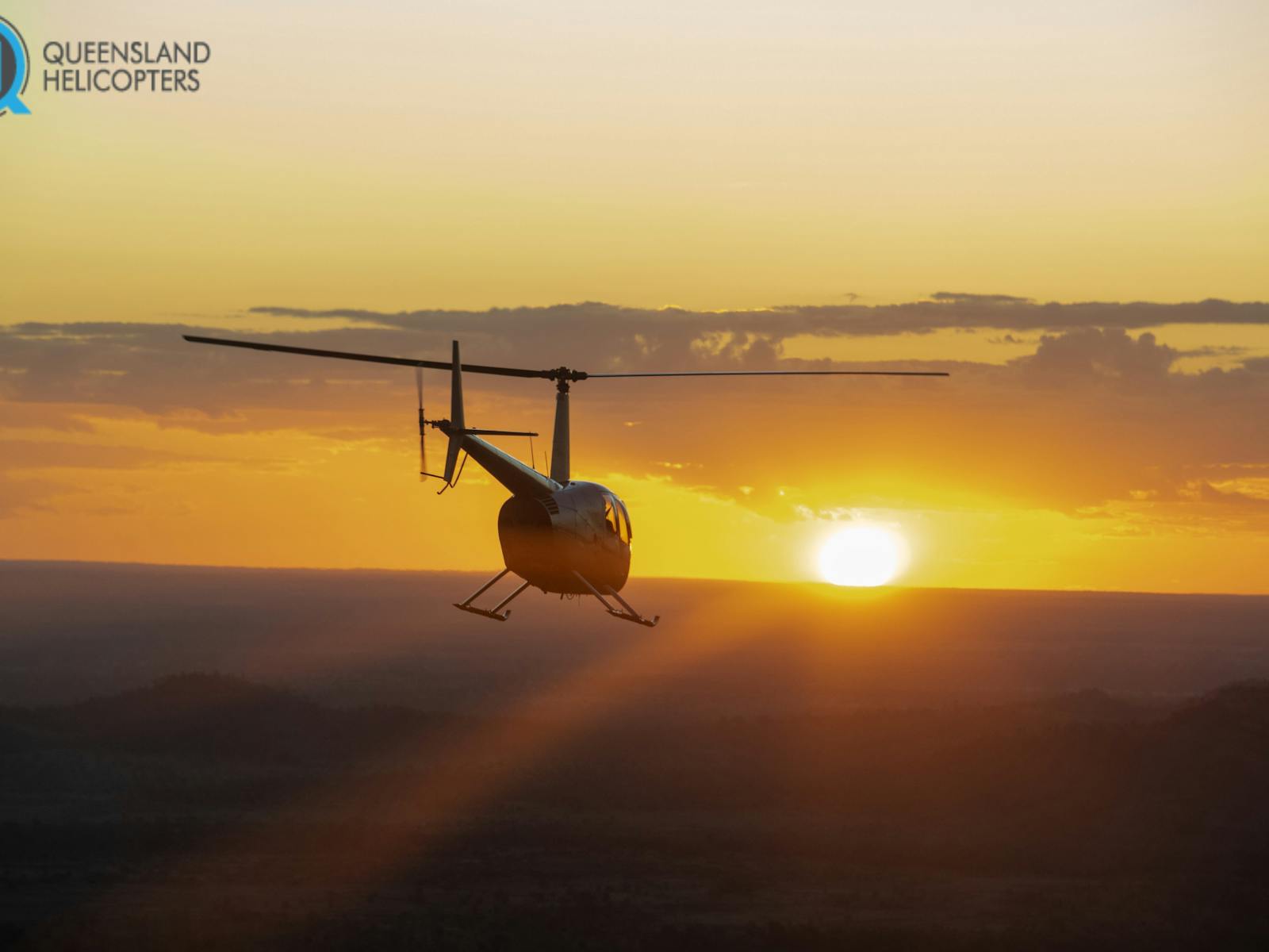 R44 Flying into sunset