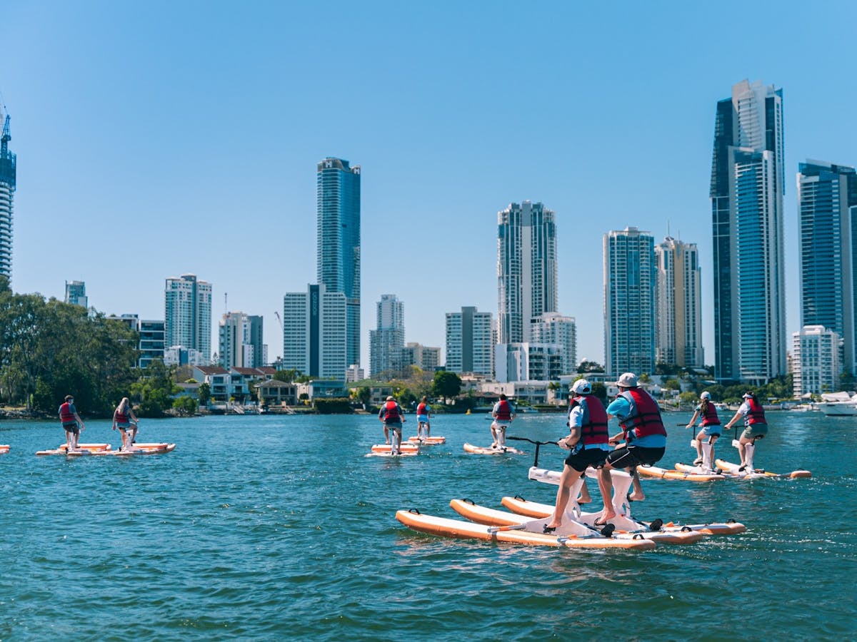 Paradise Waterbikes Group pedalling on the water with Surfers Paradise skyline Paradise Waterbikes Group pedalling on the water with Surfers Paradise skyline