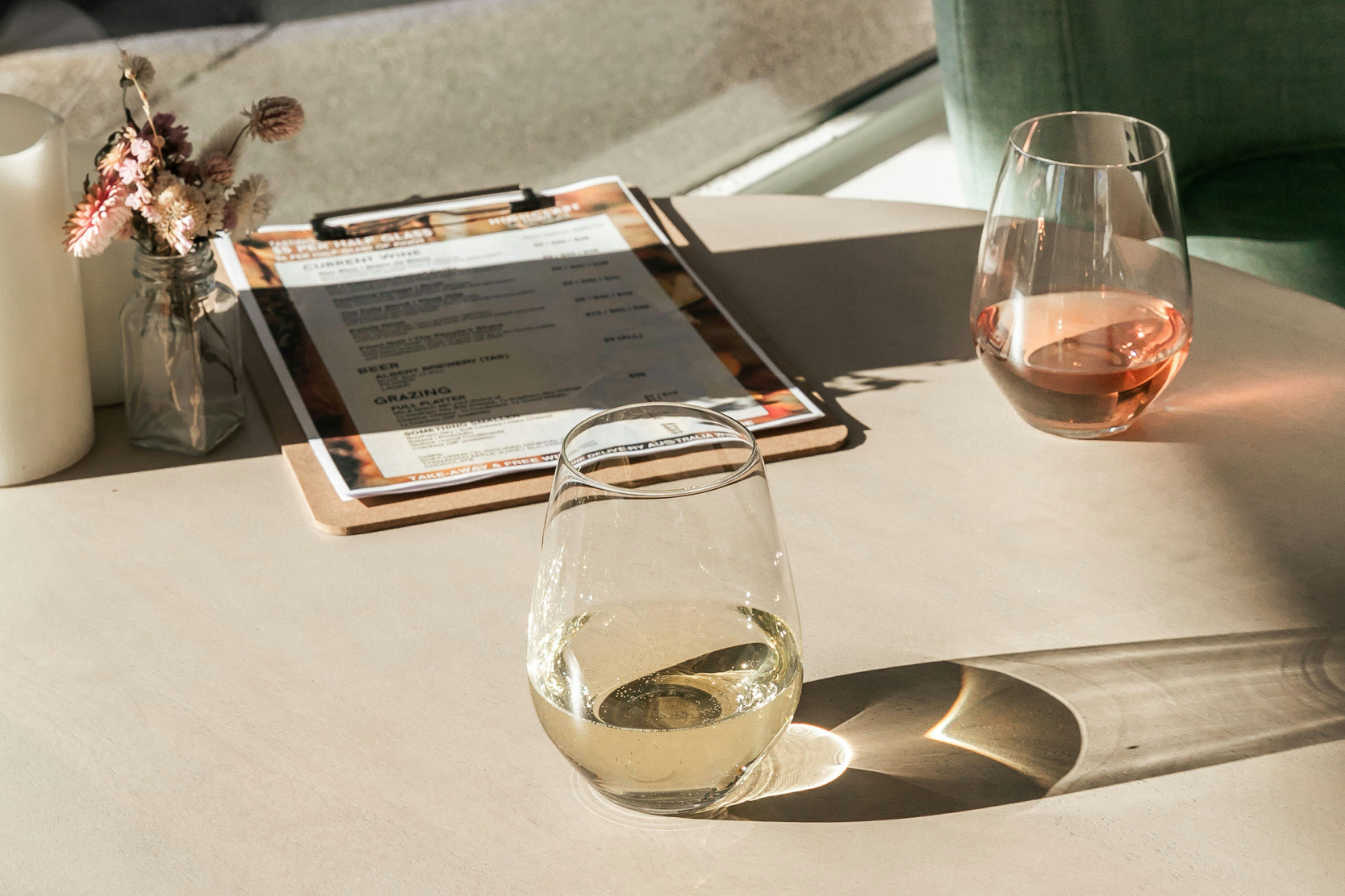 glasses of white and rose wine in the sunshine wine tasting tamar valley