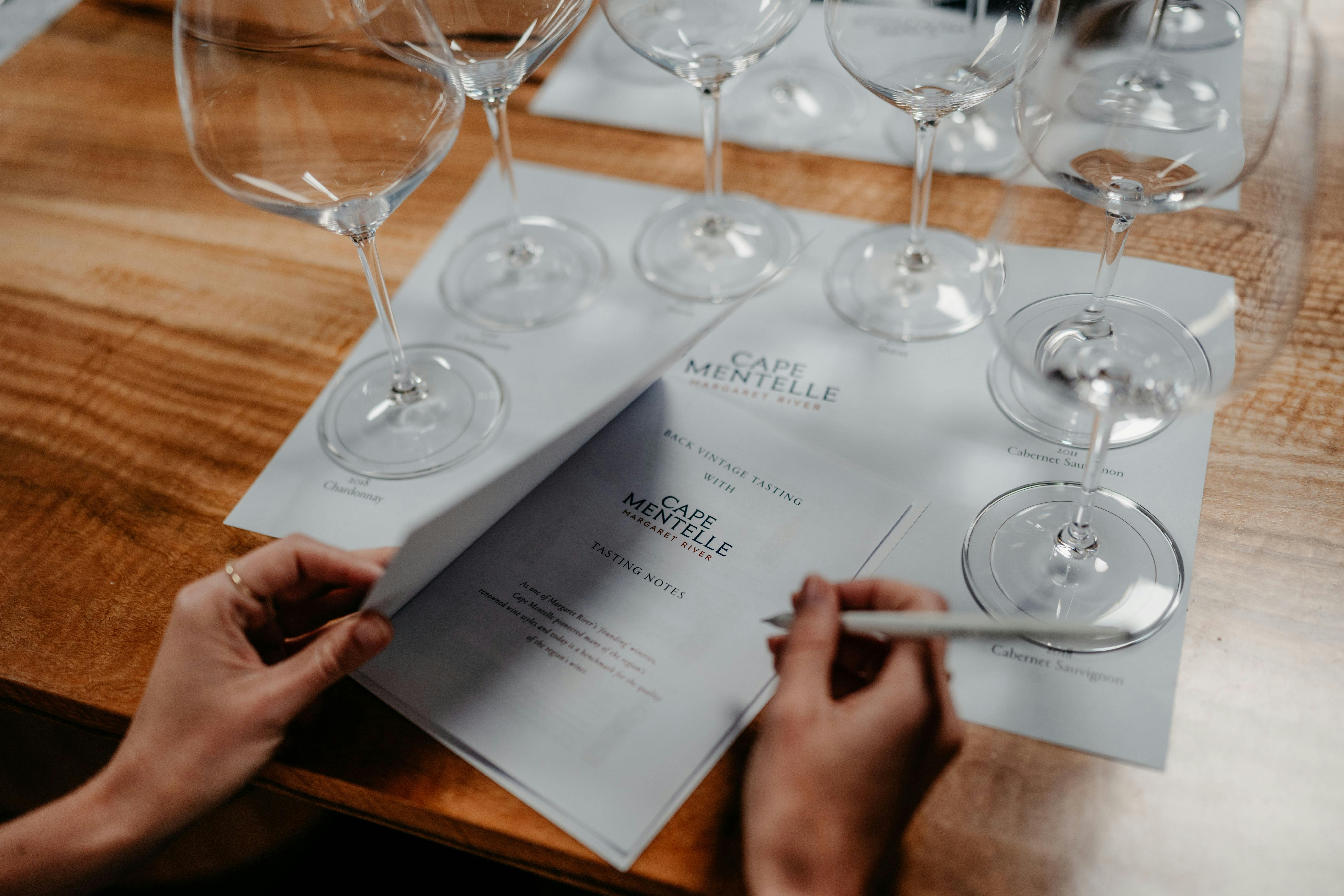 6 wine glasses are layed out on a placemat, ready for a tasting at Cape Mentelle, Margaret River