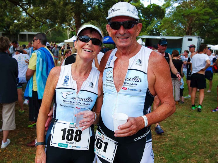 Two triathletes with post race smiles
