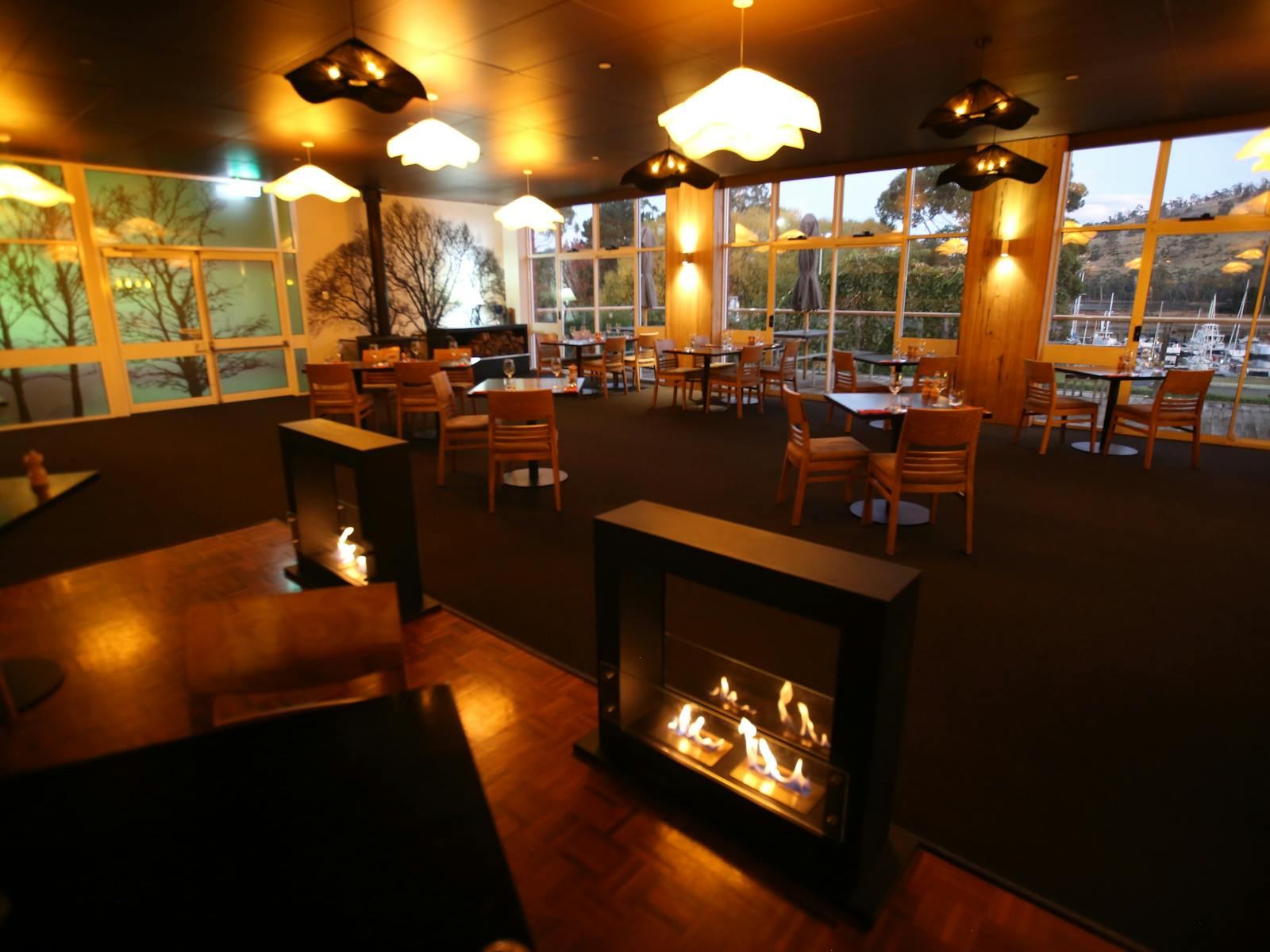 Restaurant with tables and chairs. View from windows out to the Huon River