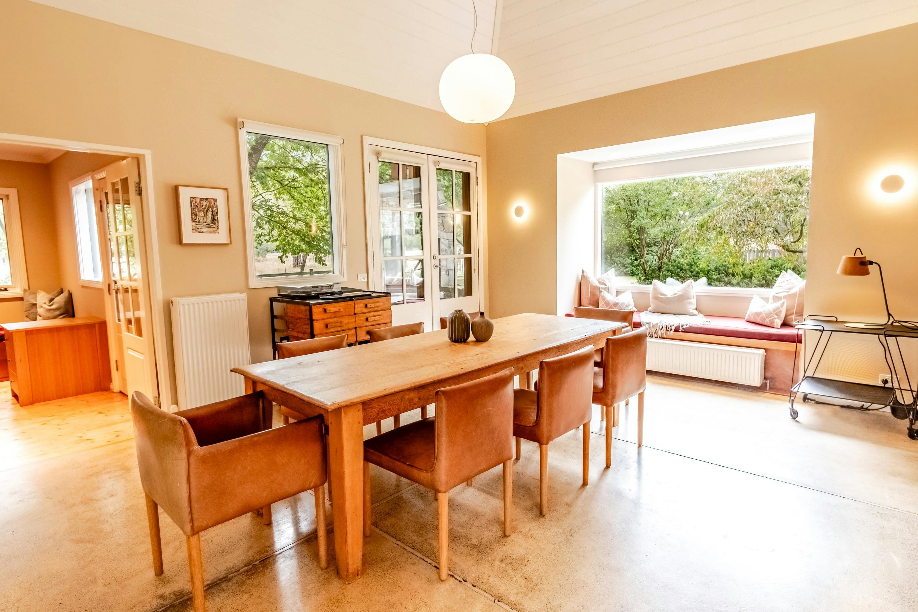 Dining area with day bed and garden views