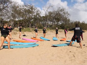 A group on the beach learning surf basics