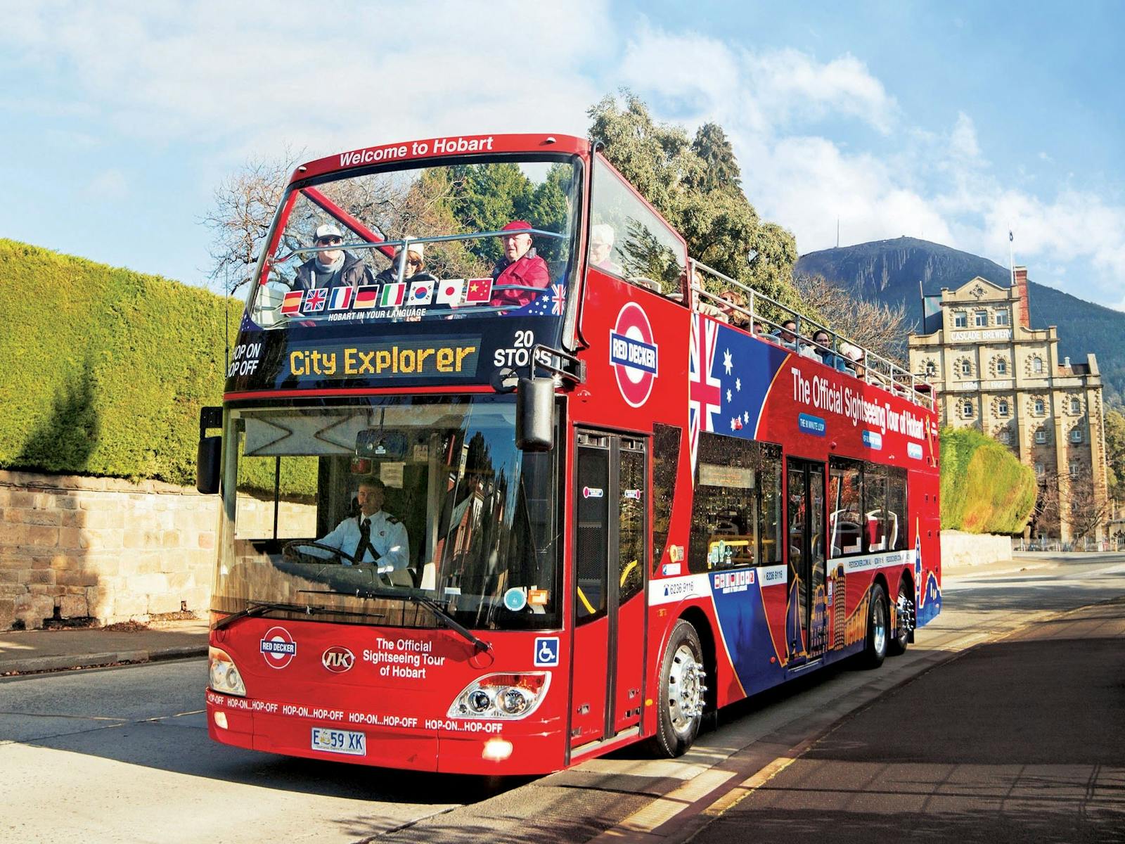 Double decker bus with Cascade Brewery and kunanyi/Mt Wellington in the background.