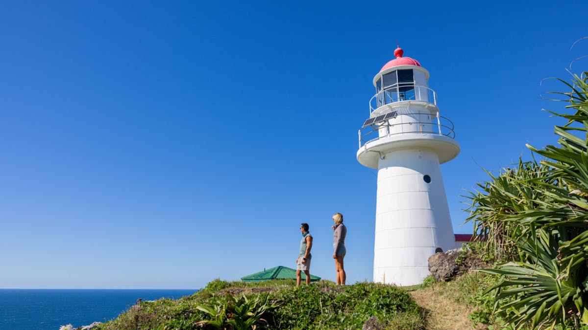People looking out at the ocean infront of the Lighthouse