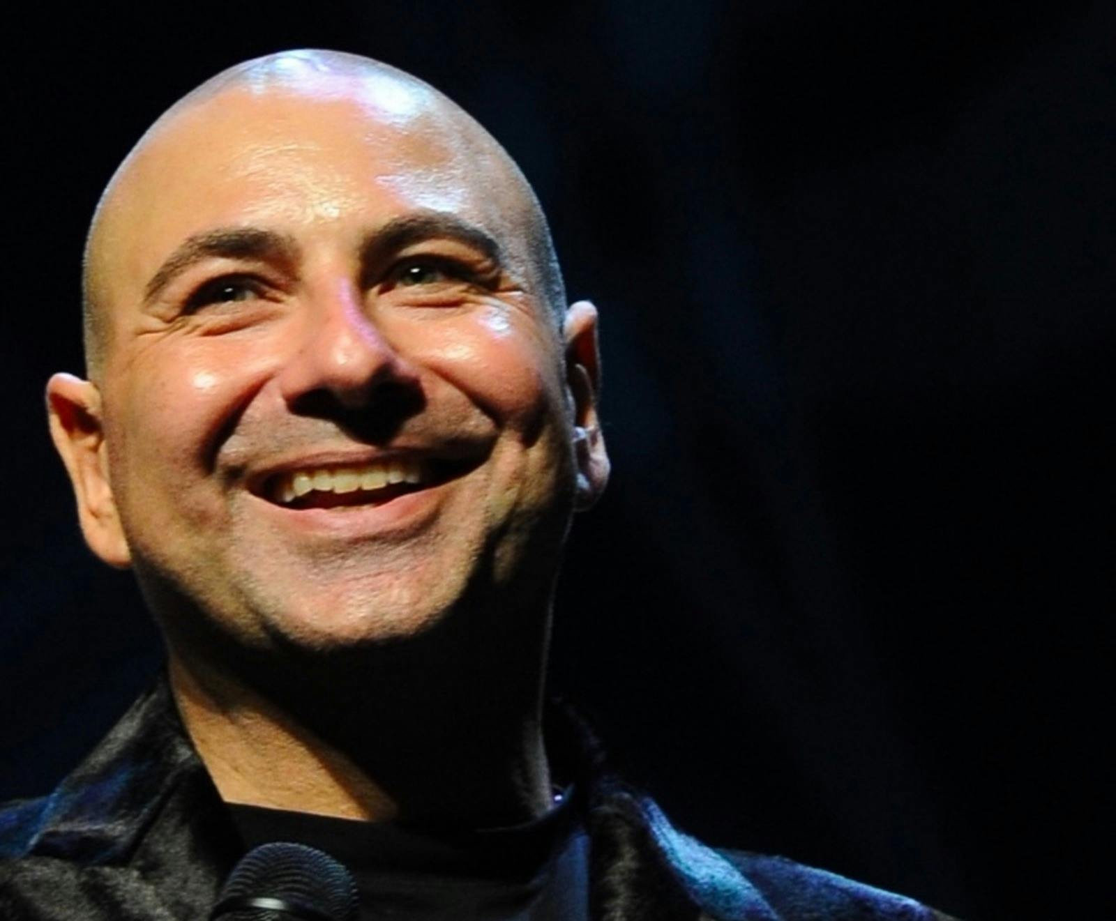 Balding man/stand up comic with mic