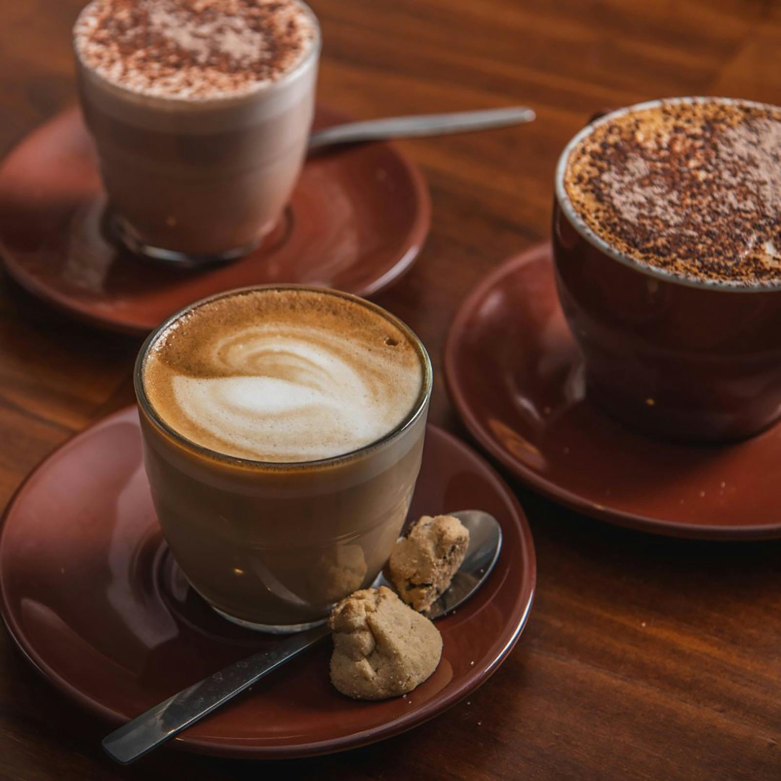 Three lattes on plates at the panthers bathurst