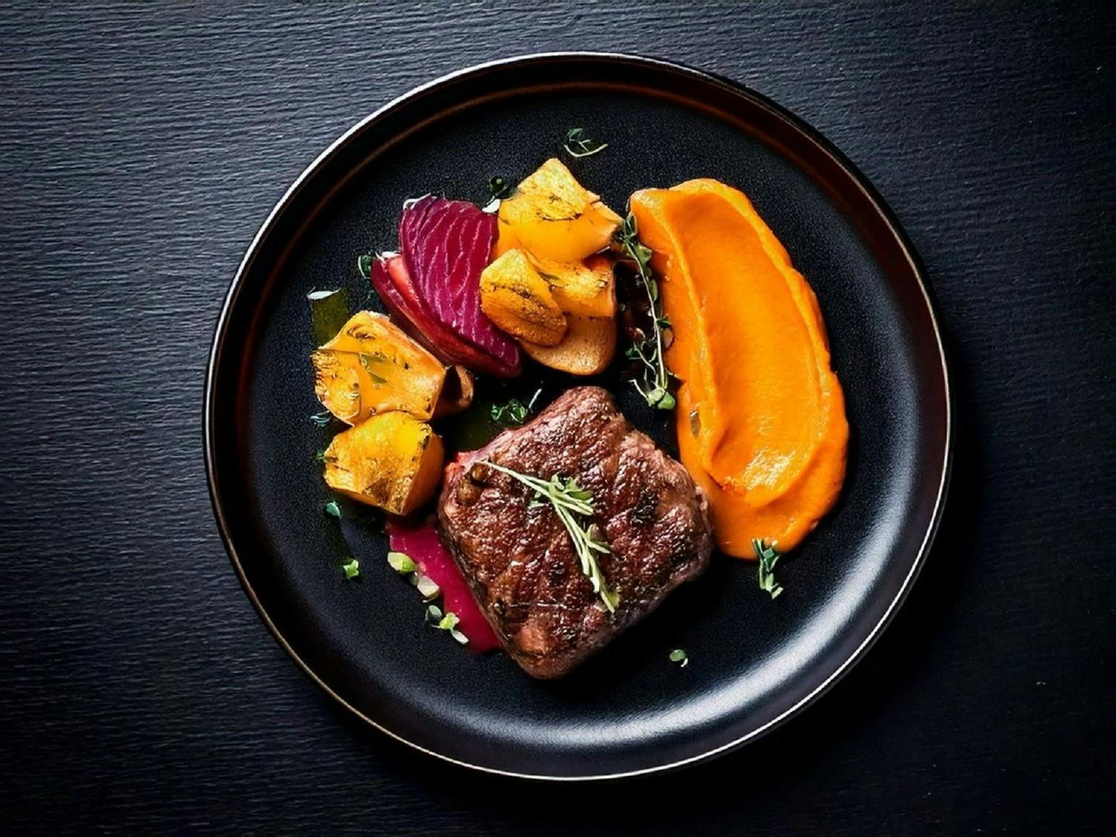 Over head of  fusion plate with Steak with sides