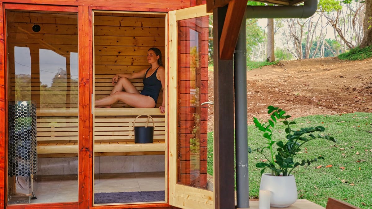 Woman relaxing in Finnish sauna at The Range Holistic Spa and Wellness, Montville Sunshine Coast