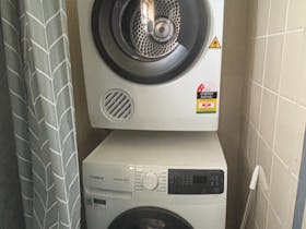 Convenient guest laundry facilities including washing machine and dryer for extended stays.
