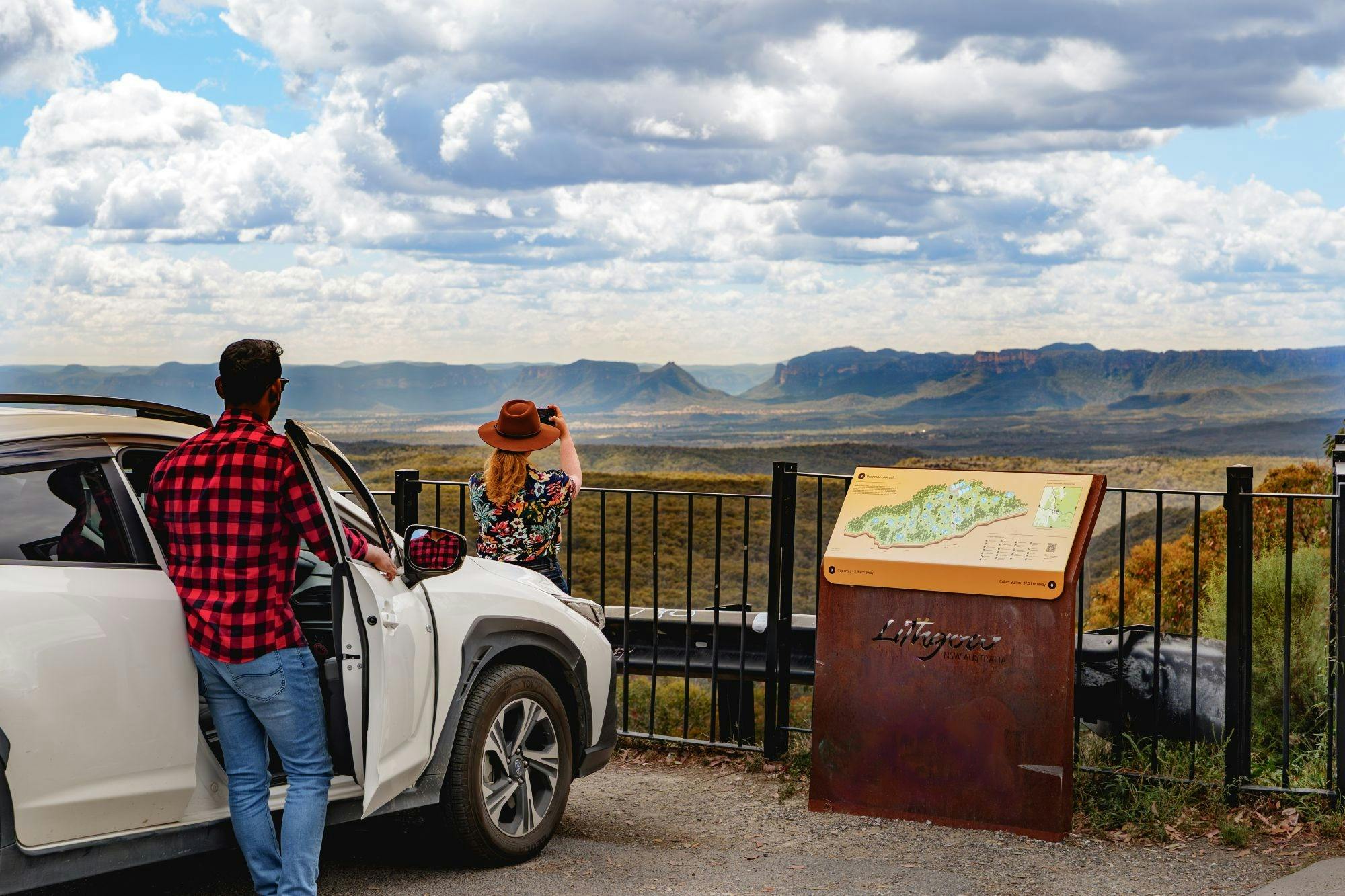 A pair of tourist take photos of the Capertee Valley from Pearsons Lookout.