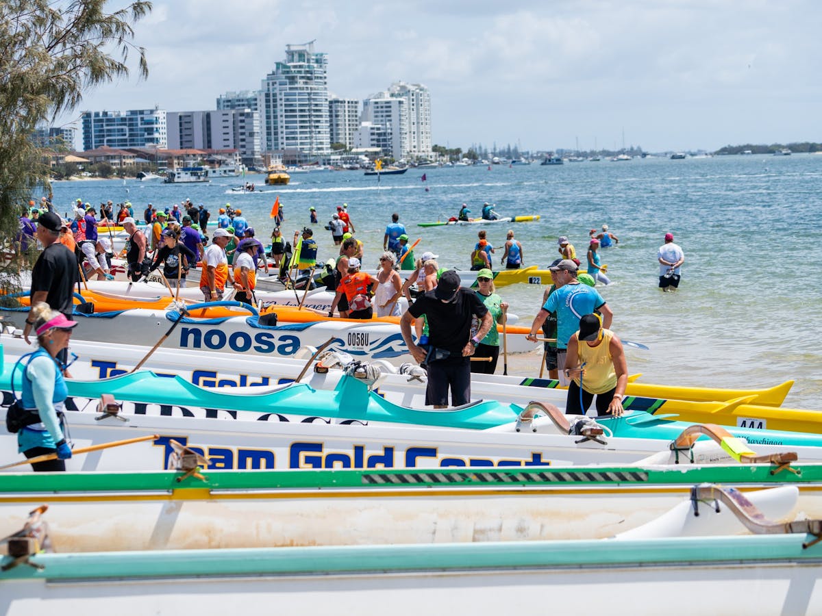 Outrigger canoes lined up on the beach before racing