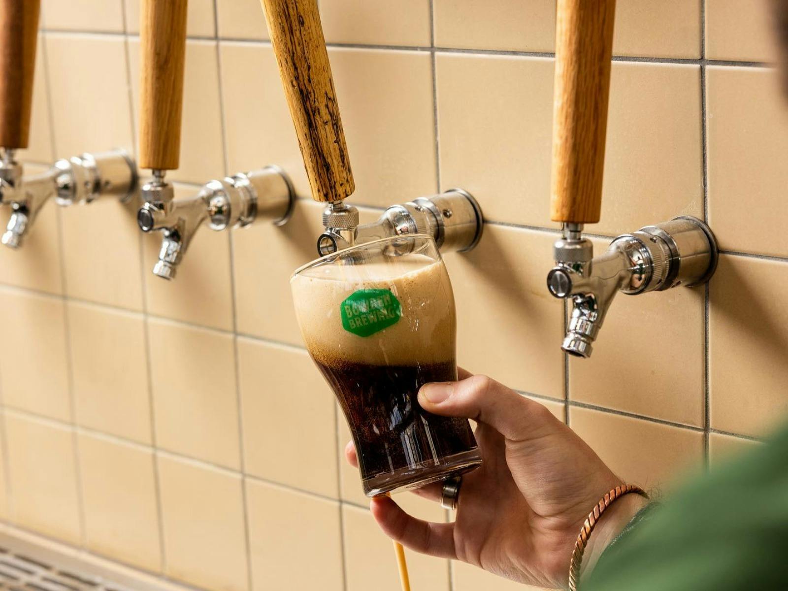 dark beer being poured from tap