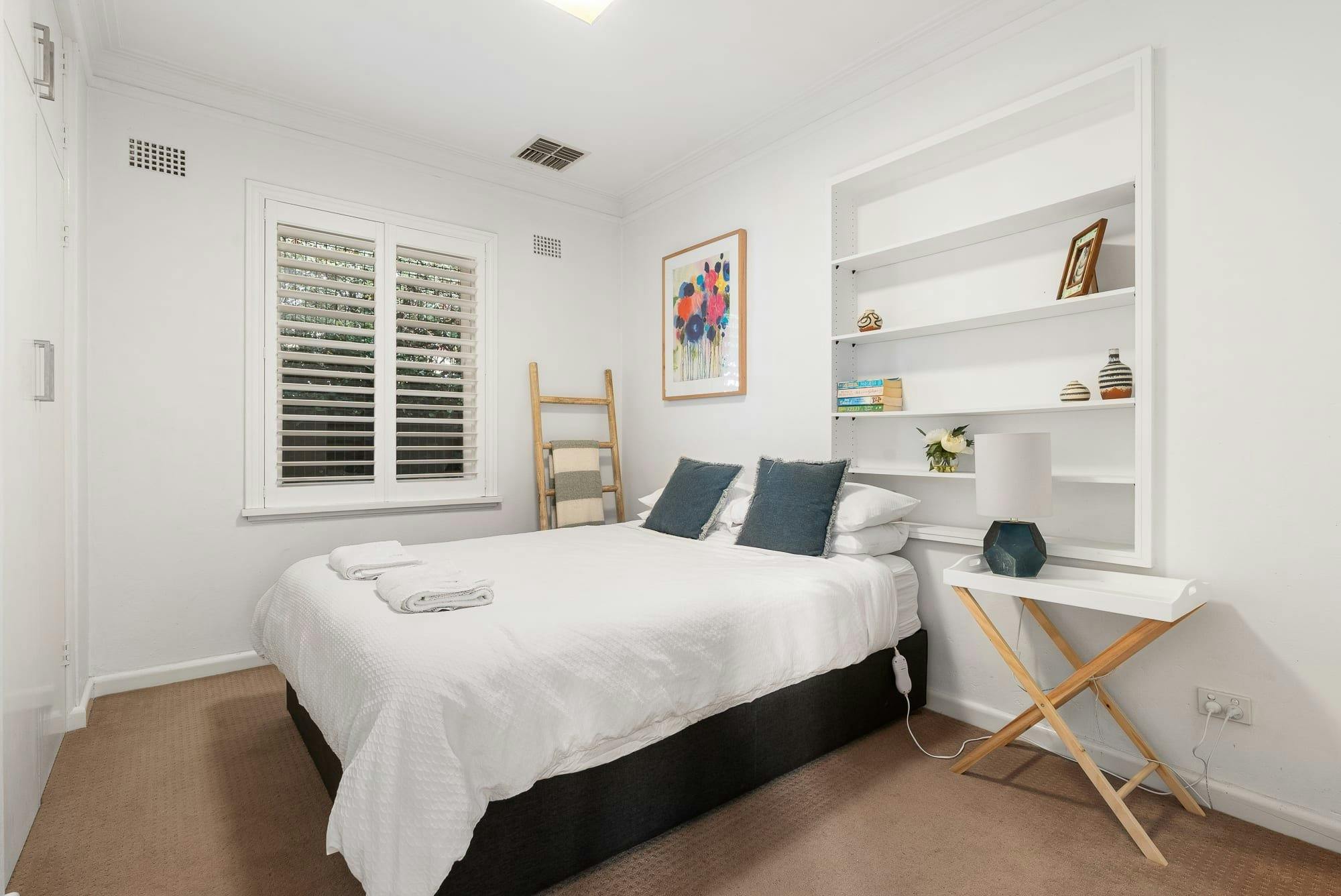 Queen bedroom with shelving and storage Stay Stylish in the Heart of Orange