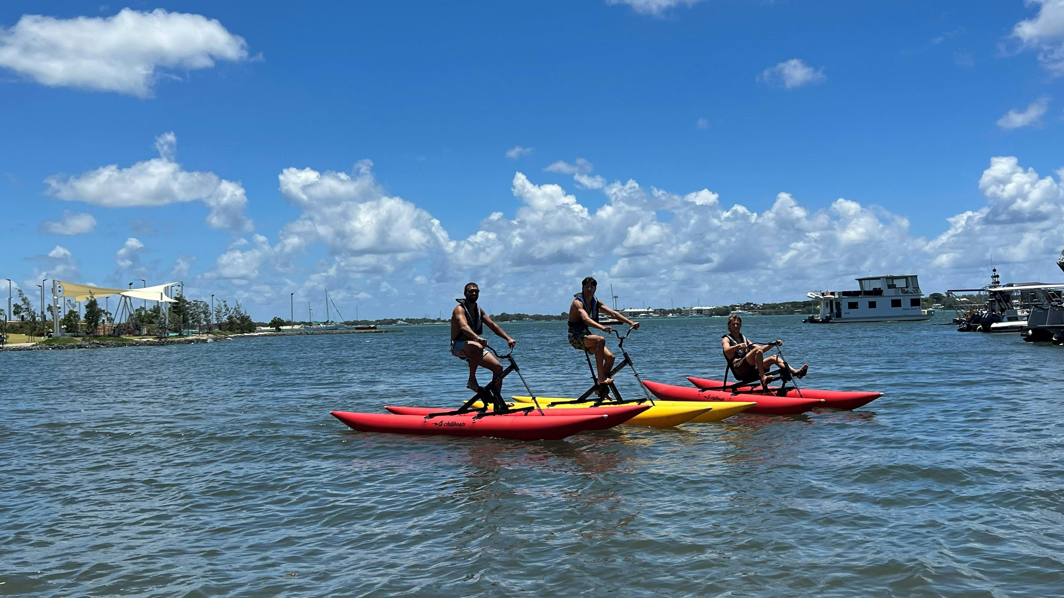 Group of young men enjoy waterbiking.