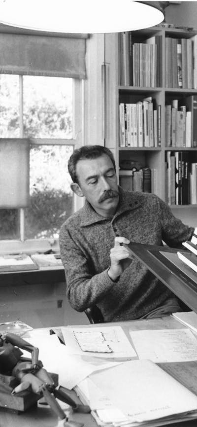 Enrico Taglietti inspecting an architectural model in his studio