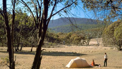 Photo of landscape with tent and two people in distance