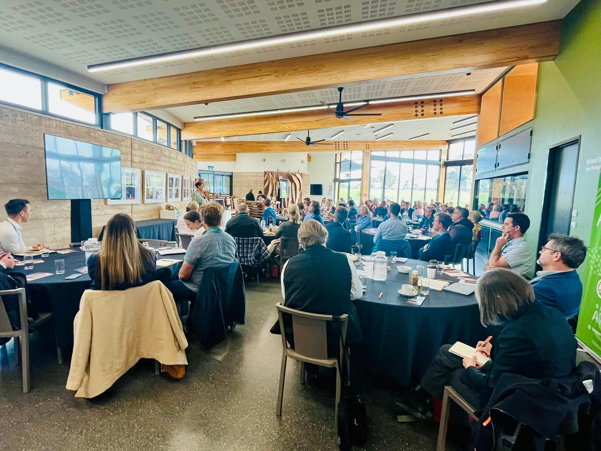 A group of people facing a speaker