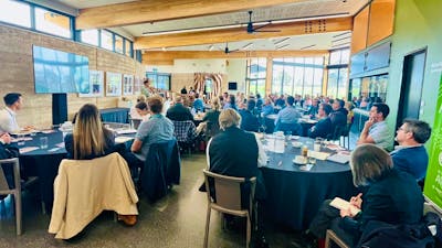 A group of people facing a speaker