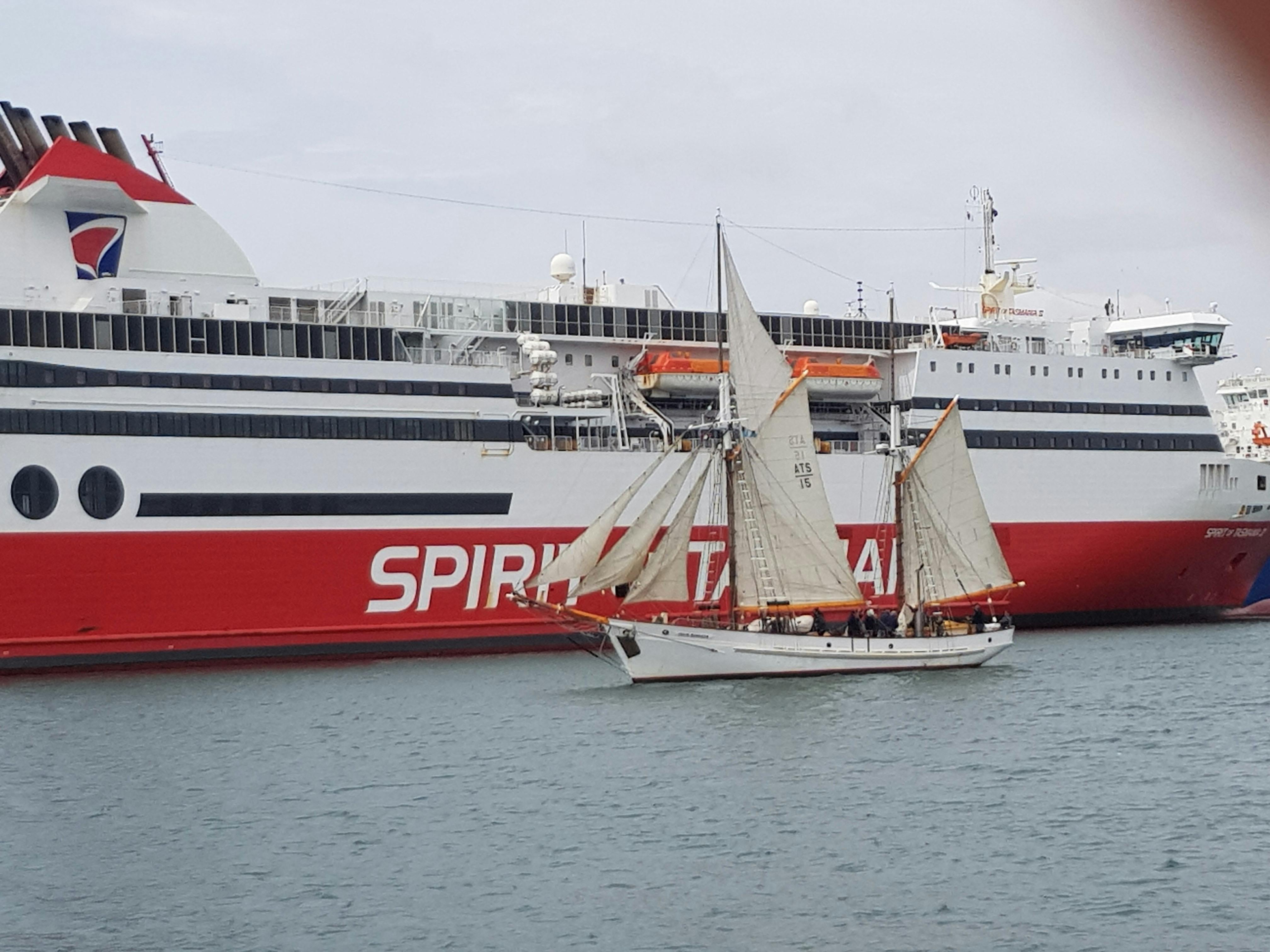 Julie Burgess, historic tall ship, sails past the Spirit of Tasmania, who is docked in Mersey River,