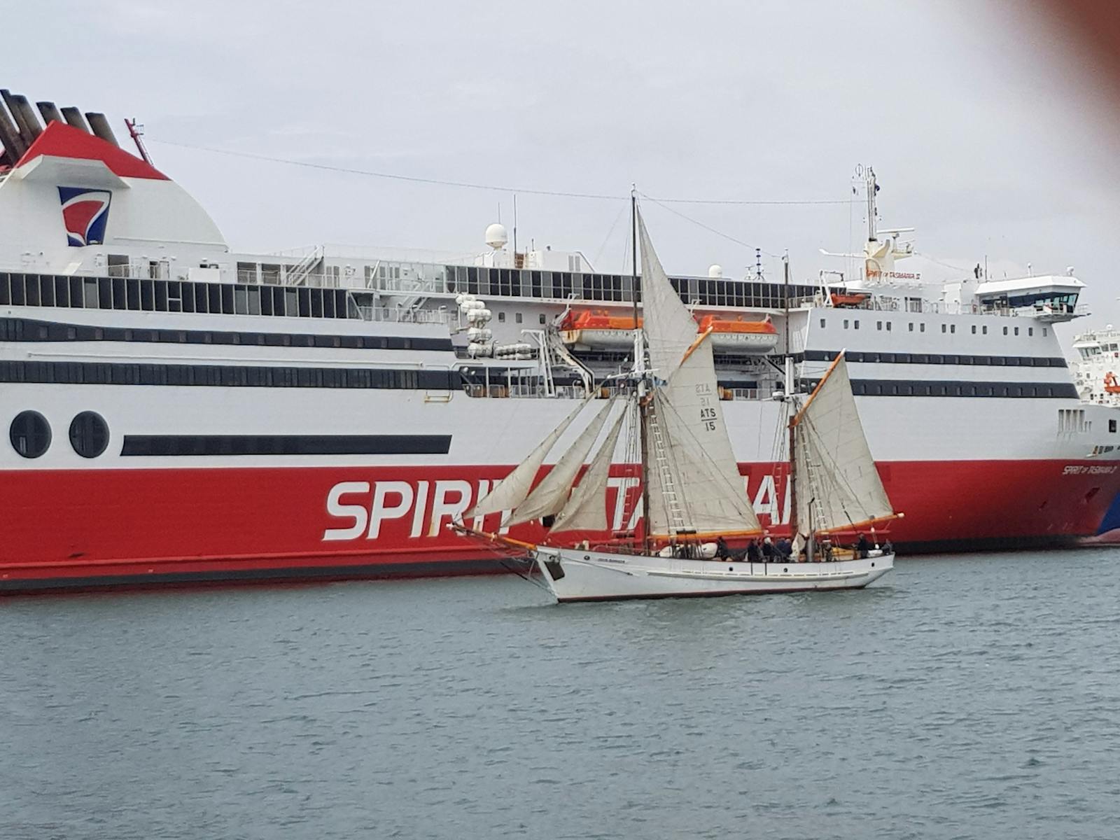 Julie Burgess, historic tall ship, sails past the Spirit of Tasmania, who is docked in Mersey River,