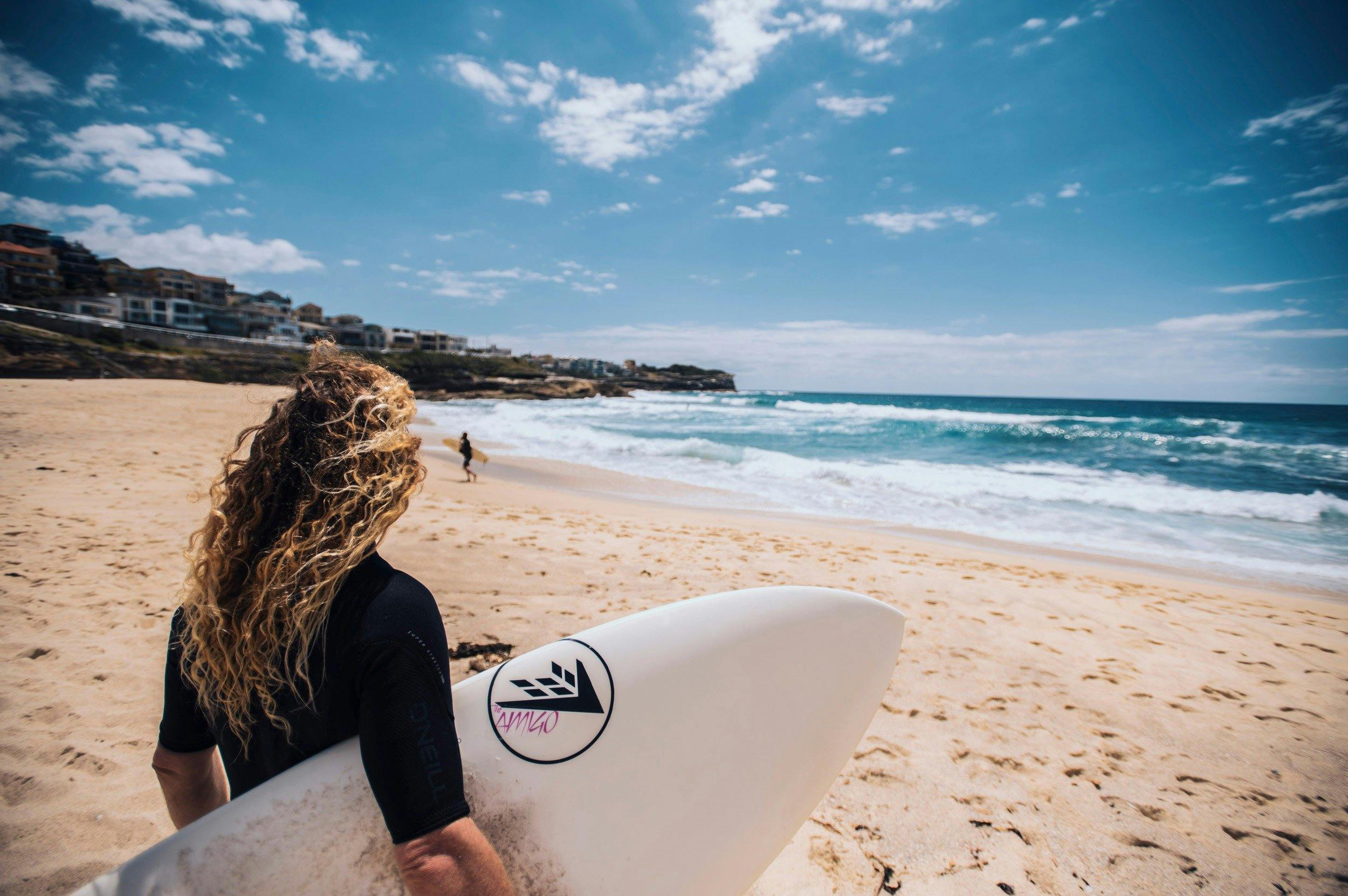 Surfer heading out to catch a wave at Bronte Beach, Sydney
