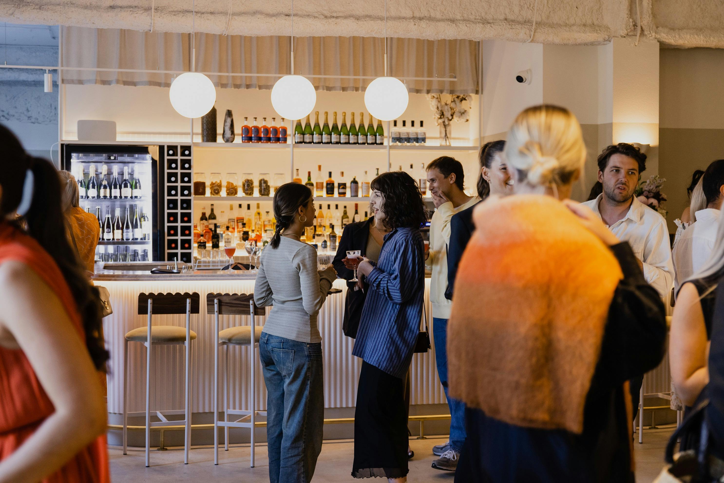 A group of people mingling at the bar