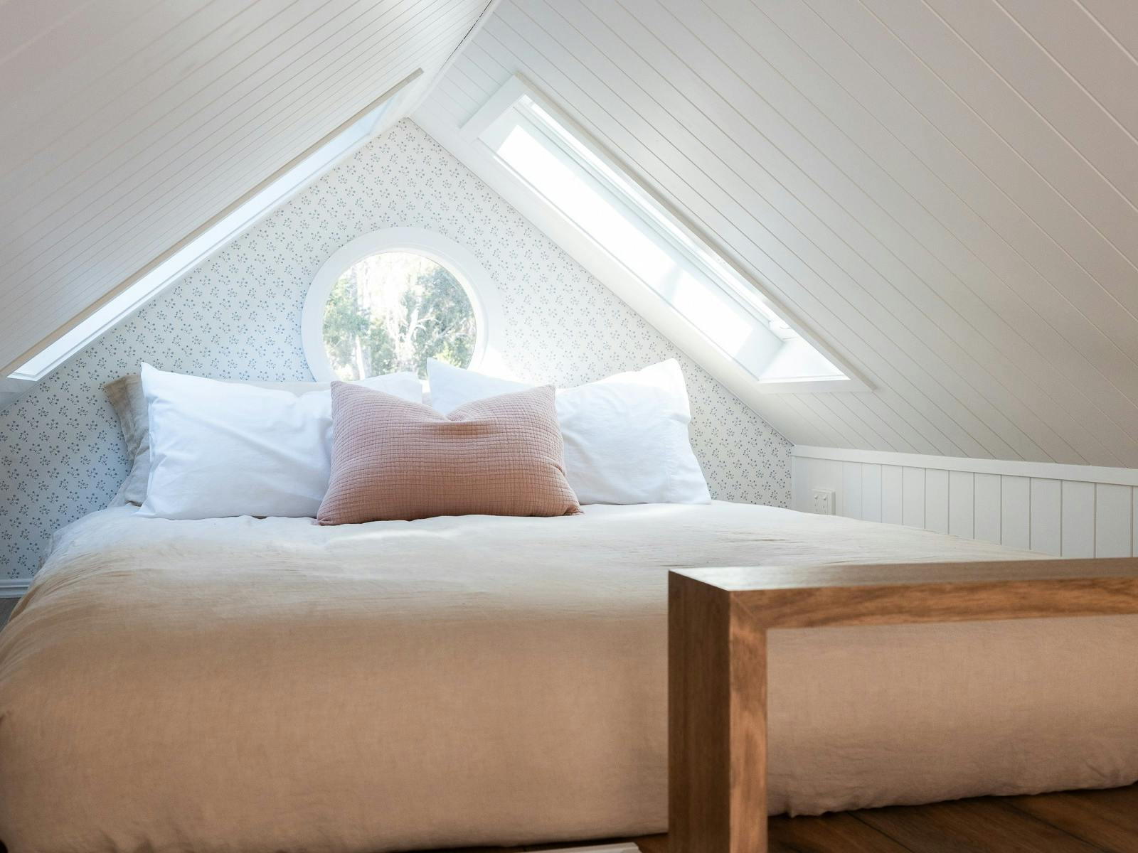 Loft bed with two skylights.