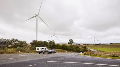 Crookwell Wind Farm with caravan and car driving through foreground