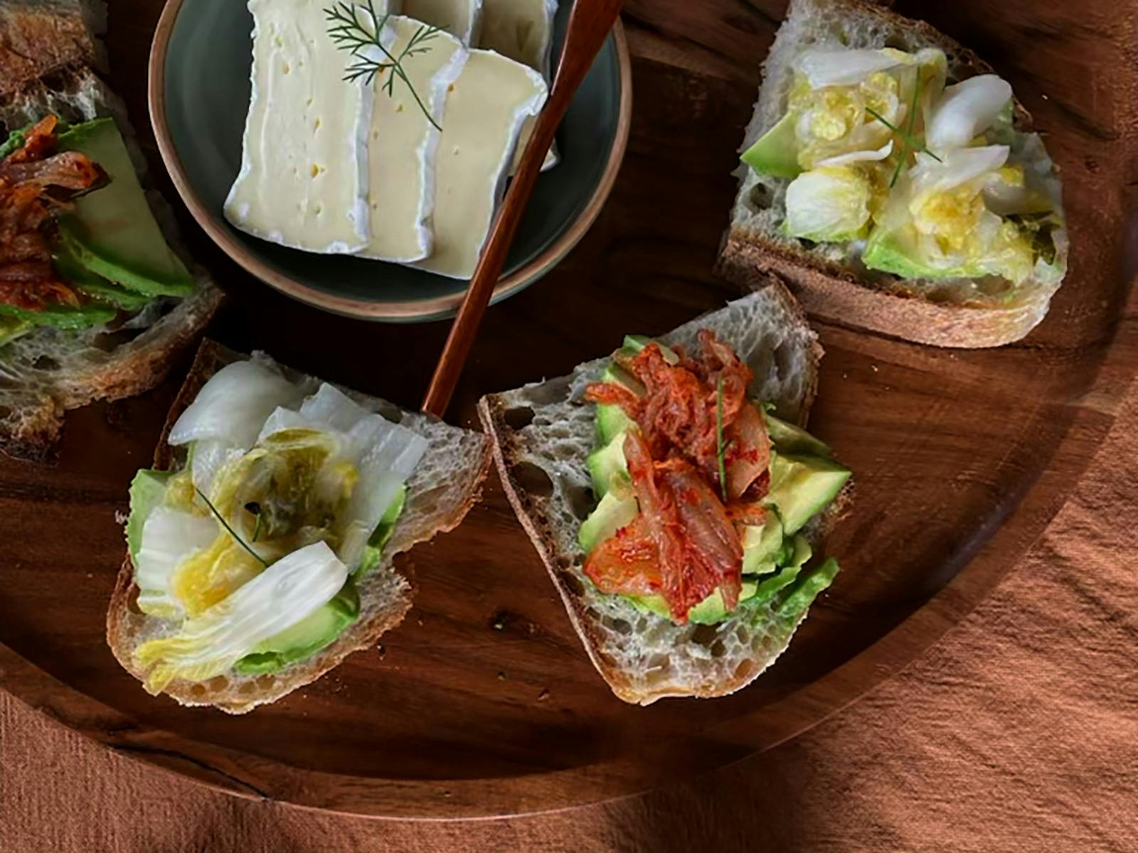 Kimchi and toast on a wood platter