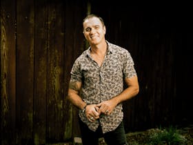 A man standing facing the camera smiling