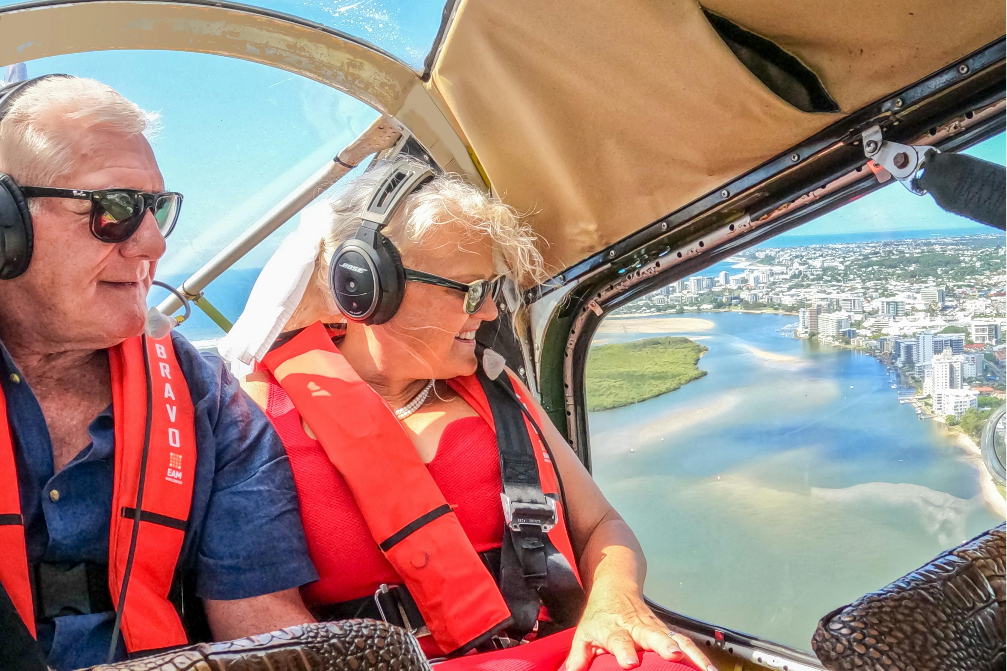 Older couple with headsets sit side by side in the back of Wilga 80 seaplane