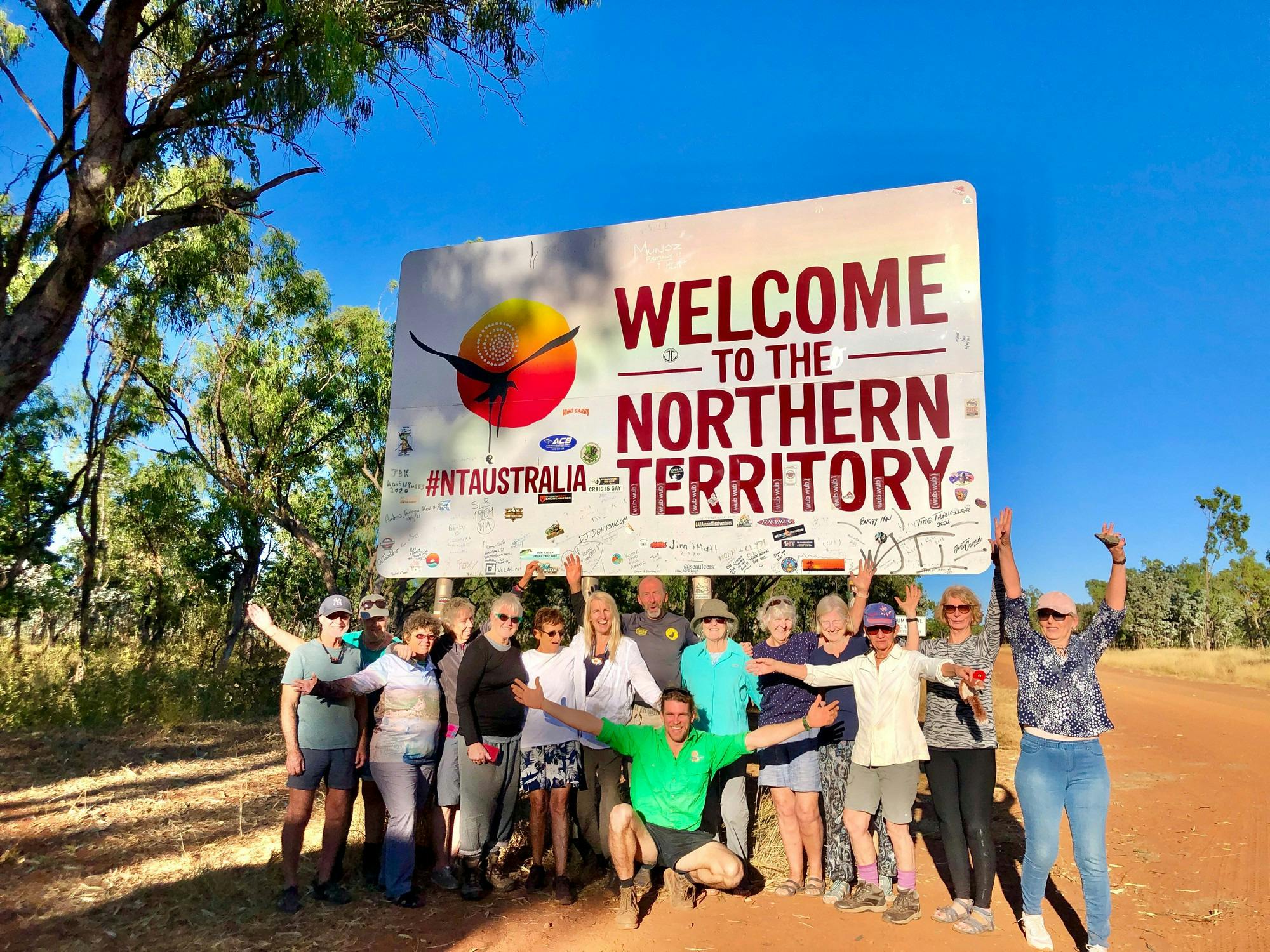 people celebrating at NT border sign
