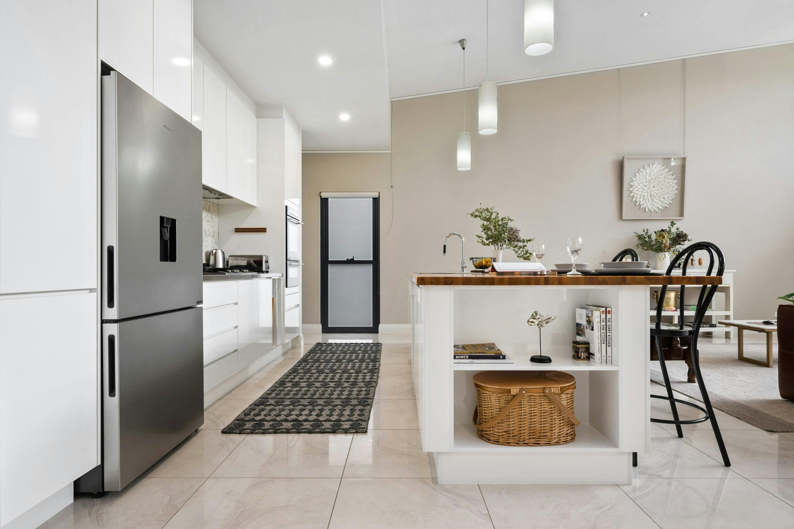 Kitchen with isalnd benches, appliances and amenities