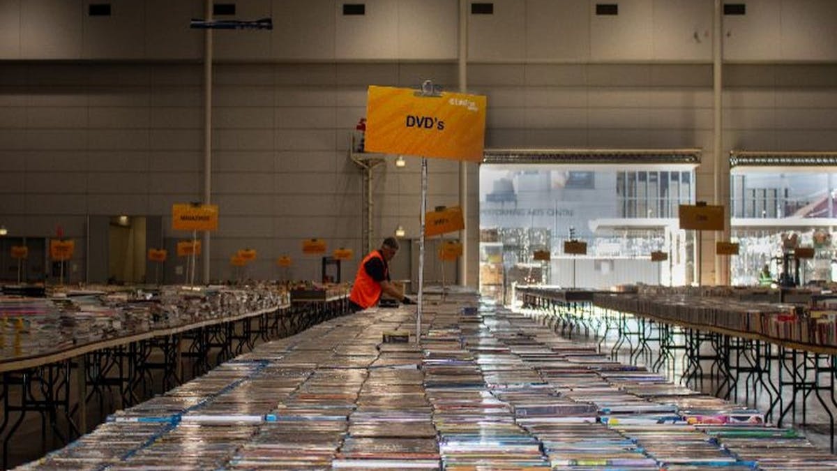 collection of DVDs arranged together along a long table collection of DVDs arranged together along a long table