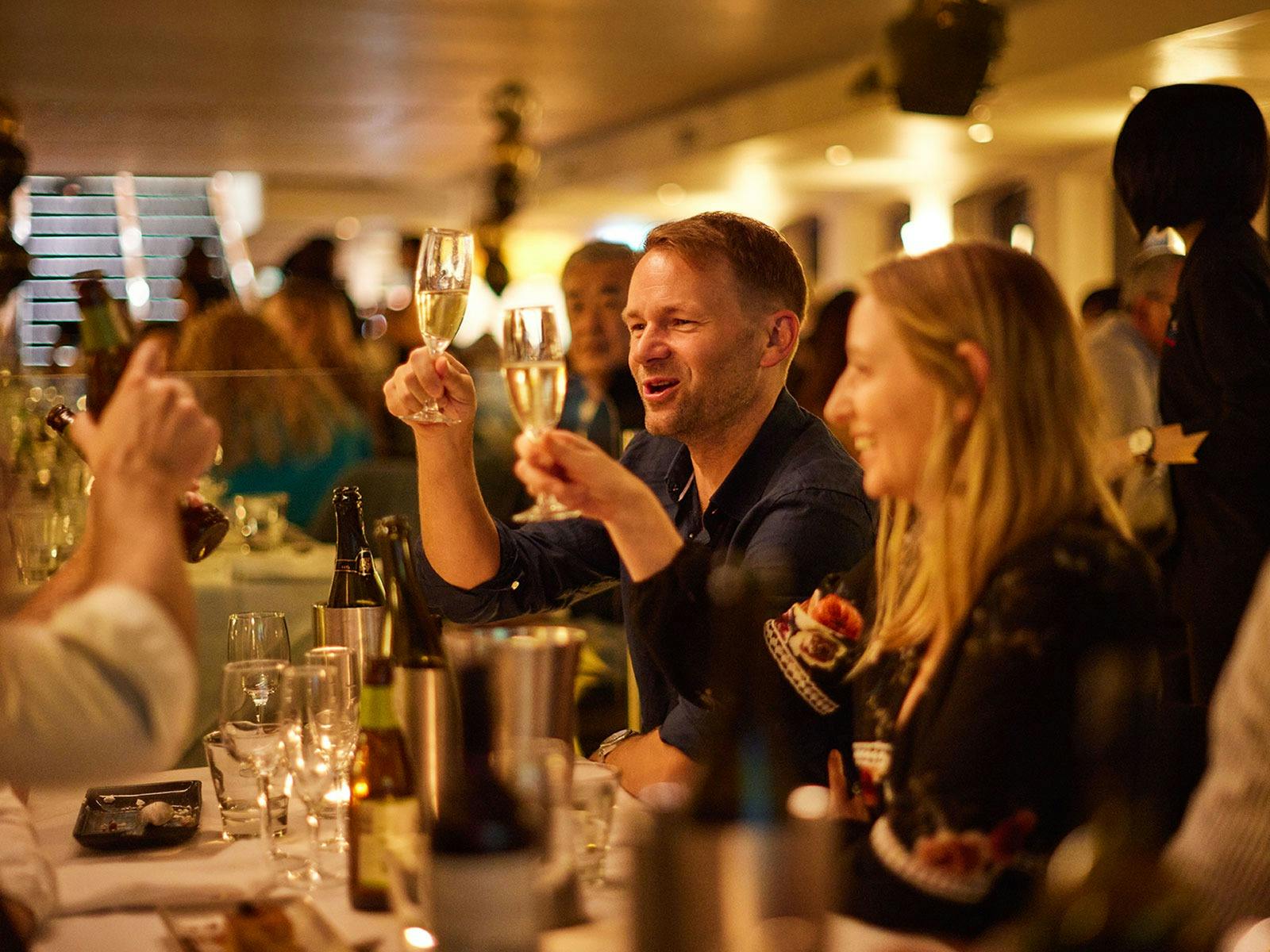 People celebrating on board the Showboat Dinner Cruise