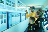 Master Reef Guide and family in underwater observatory