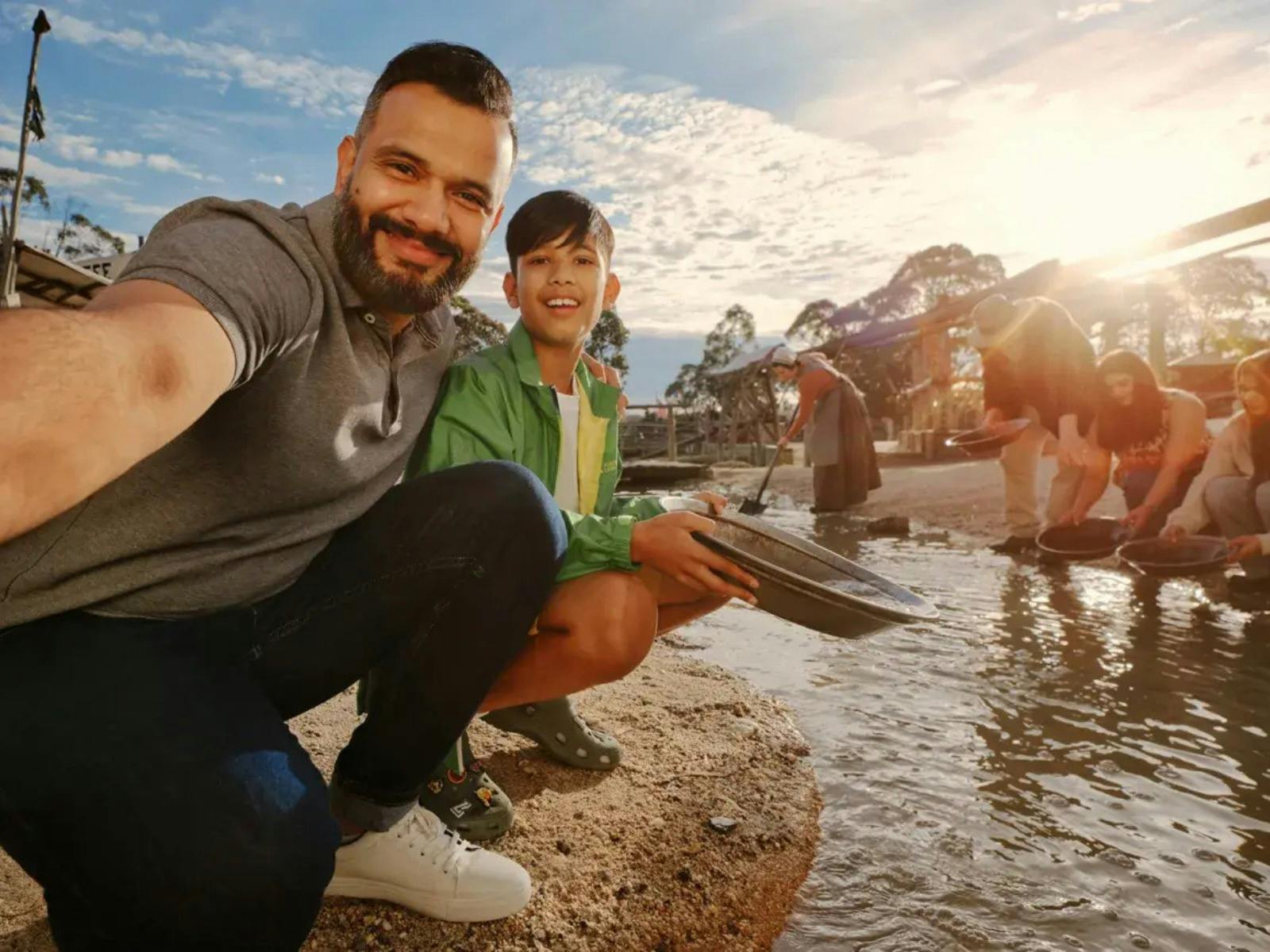 Dad and son taking a selfie while panning for gold